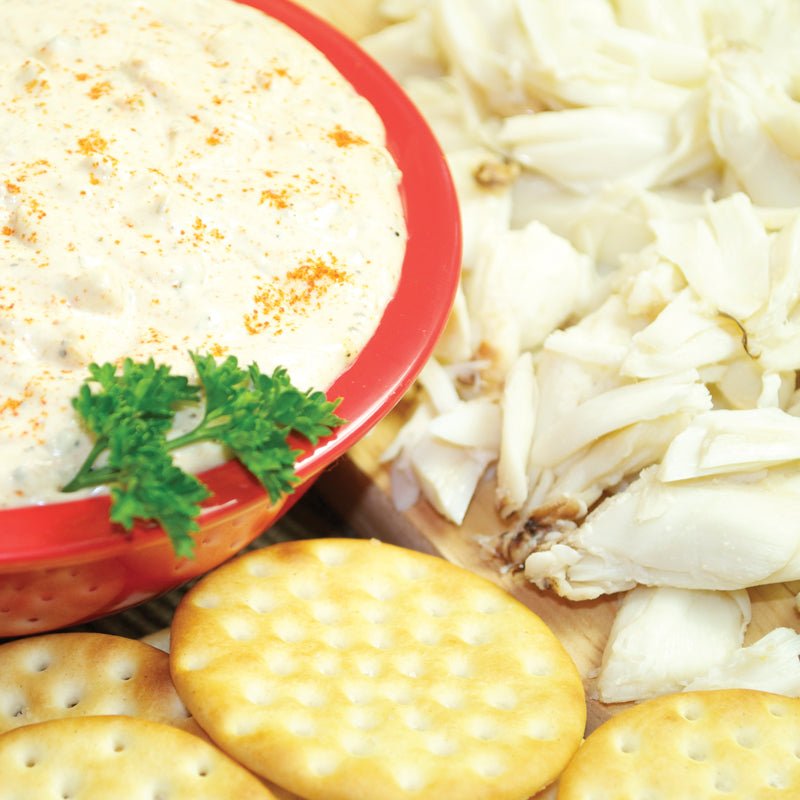 Wicked Good Crab gourmet dip in a red bowl with crab meat, parsley and round crackers